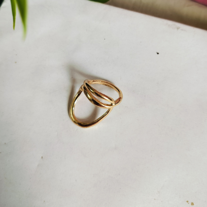 A handcrafted twisted gold ring symbolizing eternal love, grace, and timeless beauty.